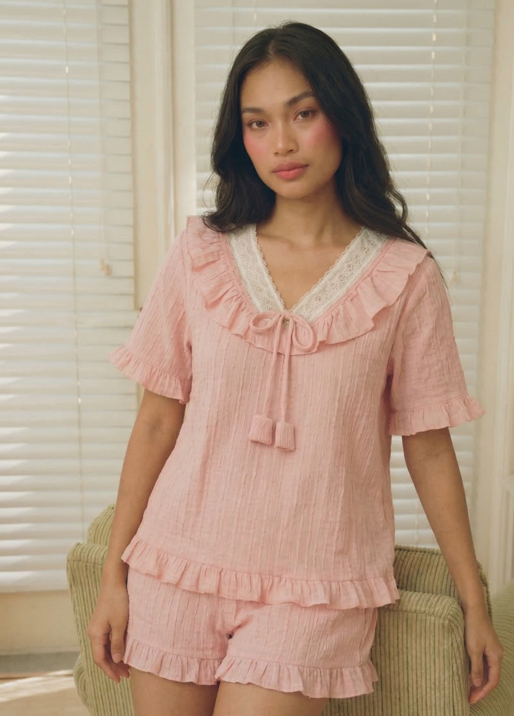 Woman wearing a pink pajama set 