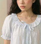 close-up of a woman wearing a blue pajama set