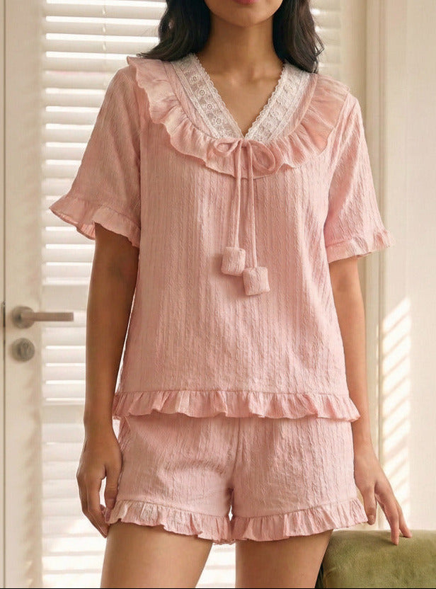 woman wearing a cute pink pajamas set in a it room